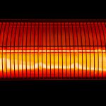Halogen wall heater abstract close up shot on black background.